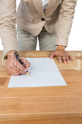 Mid section of businesswoman filling mortgage contract form