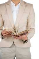 Mid section of Businesswoman flips through the pages of a book