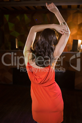 Young woman dancing on dance floor