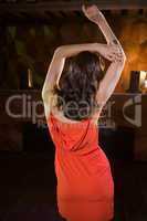 Young woman dancing on dance floor