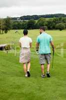 Couple walking on a golf course
