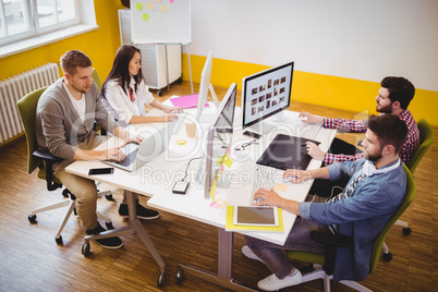 High angle view of editors working at creative office