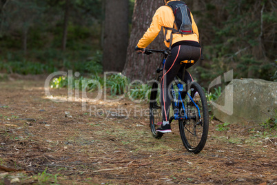 Female biker cycling in countryside