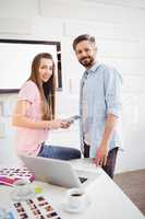 Portrait of editors with tablet computer at creative office