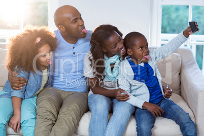 Family taking selfie from mobile phone