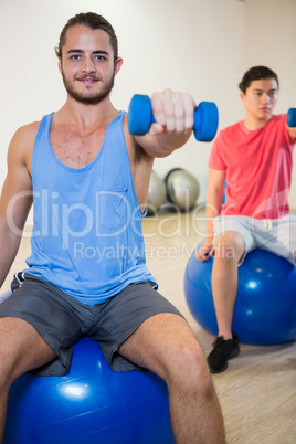 Men exercising on exercise ball