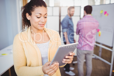 Businesswoman using digital tablet at creative office