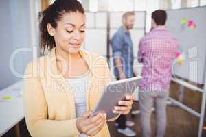 Businesswoman using digital tablet at creative office