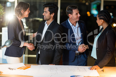 Group of businesspeople shaking hands with each other