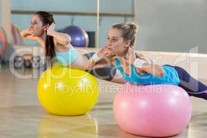 Two women exercising on exercise ball