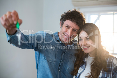 Couple holding the key of new home
