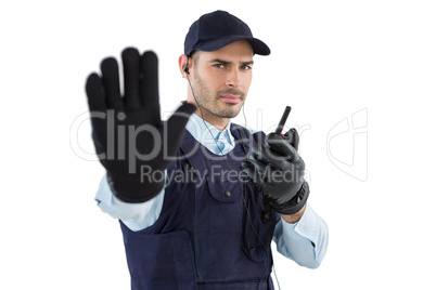 Confident security officer making stop gesture