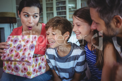 Family opening the surprise gift  in living room