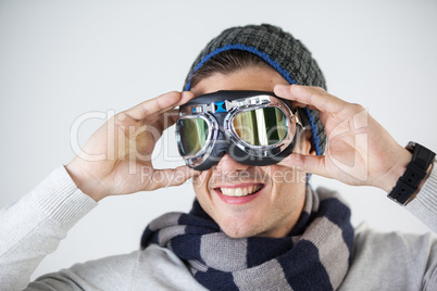 Man in winter clothing wearing aviator goggles