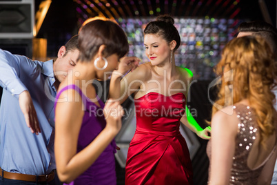 Smiling friends dancing on dance floor