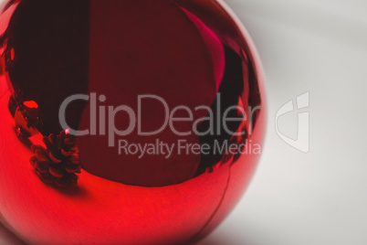 Red christmas bauble on wooden table
