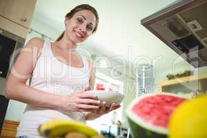 Smiling woman holding a plate of watermelon
