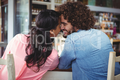 Couple romancing in cafeteria