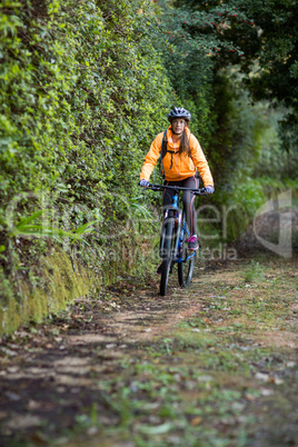 Female biker cycling in countryside