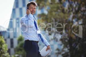 Handsome businessman talking on mobile phone