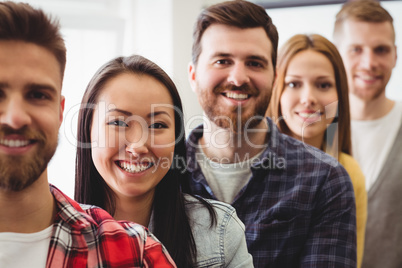 Happy creative business people standing in row