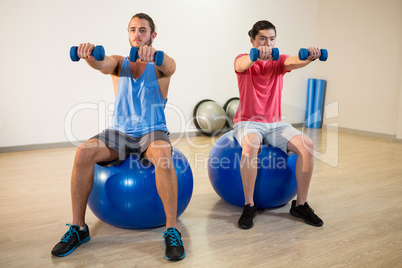 Men exercising on exercise ball