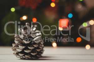 Close-up of pine cone on wooden table