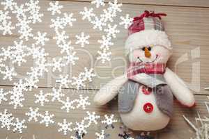 Snowman and christmas decoration on wooden table