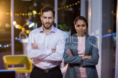 Businessman and woman standing in office