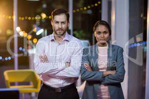 Businessman and woman standing in office