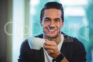Handsome man having a cup of coffee in cafÃ?Â©