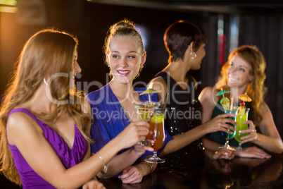 Friends having glass of cocktail in bar