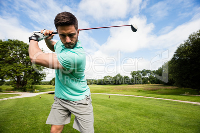 Focused man playing golf