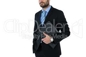 Mid section of businessman holding folder