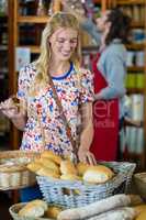 Smiling woman purchasing bread