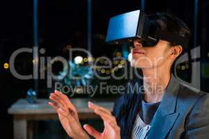 Businesswoman using virtual reality headset