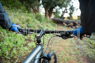 Close-up of male mountain biker riding bicycle