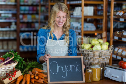 Female staff holding organic sign board