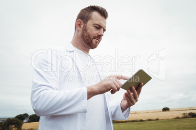 Agronomist using digital tablet in the field