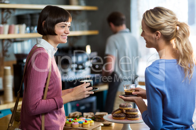 Female friends having a cup of coffee in cafÃ?Â©