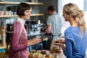 Female friends having a cup of coffee in cafÃ?Â©