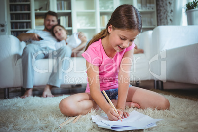 Girl sitting on the floor and drawing