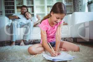 Girl sitting on the floor and drawing