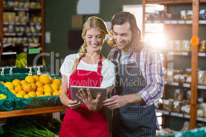 Staffs using digital tablet in organic section