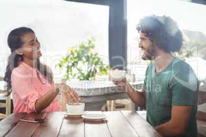 Couple interacting with each other while having coffee