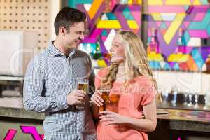 Couple holding a glass of beer in bar