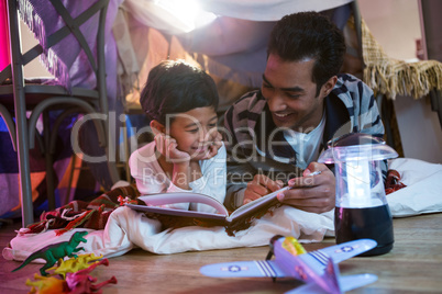 Father and son reading book