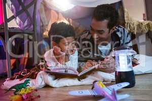 Father and son reading book