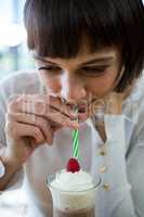 Woman drinking milkshake with a straw