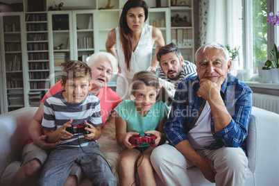 Family watching the kids playing video game